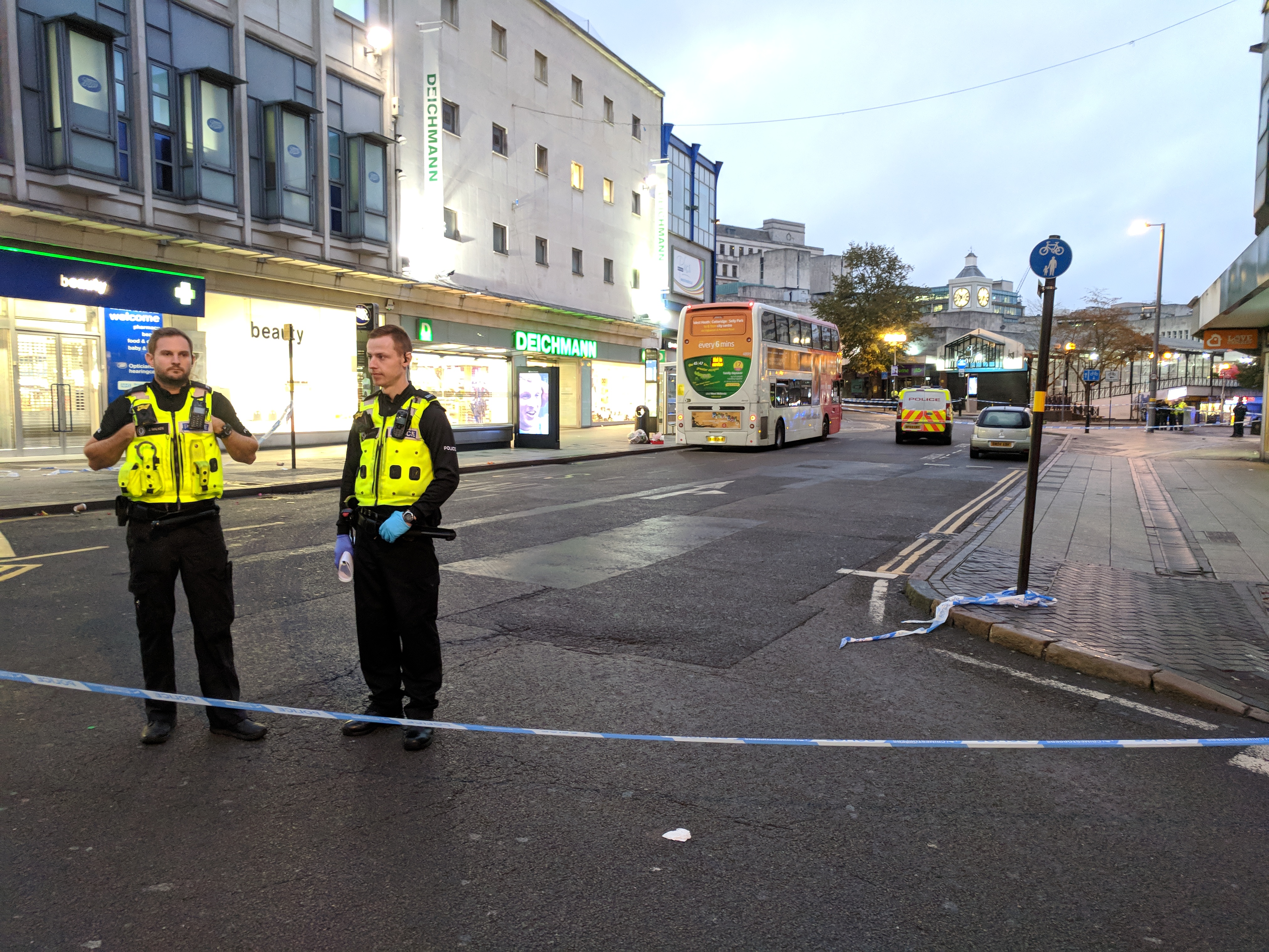 Area sealed off with police tape with two officers standing guard